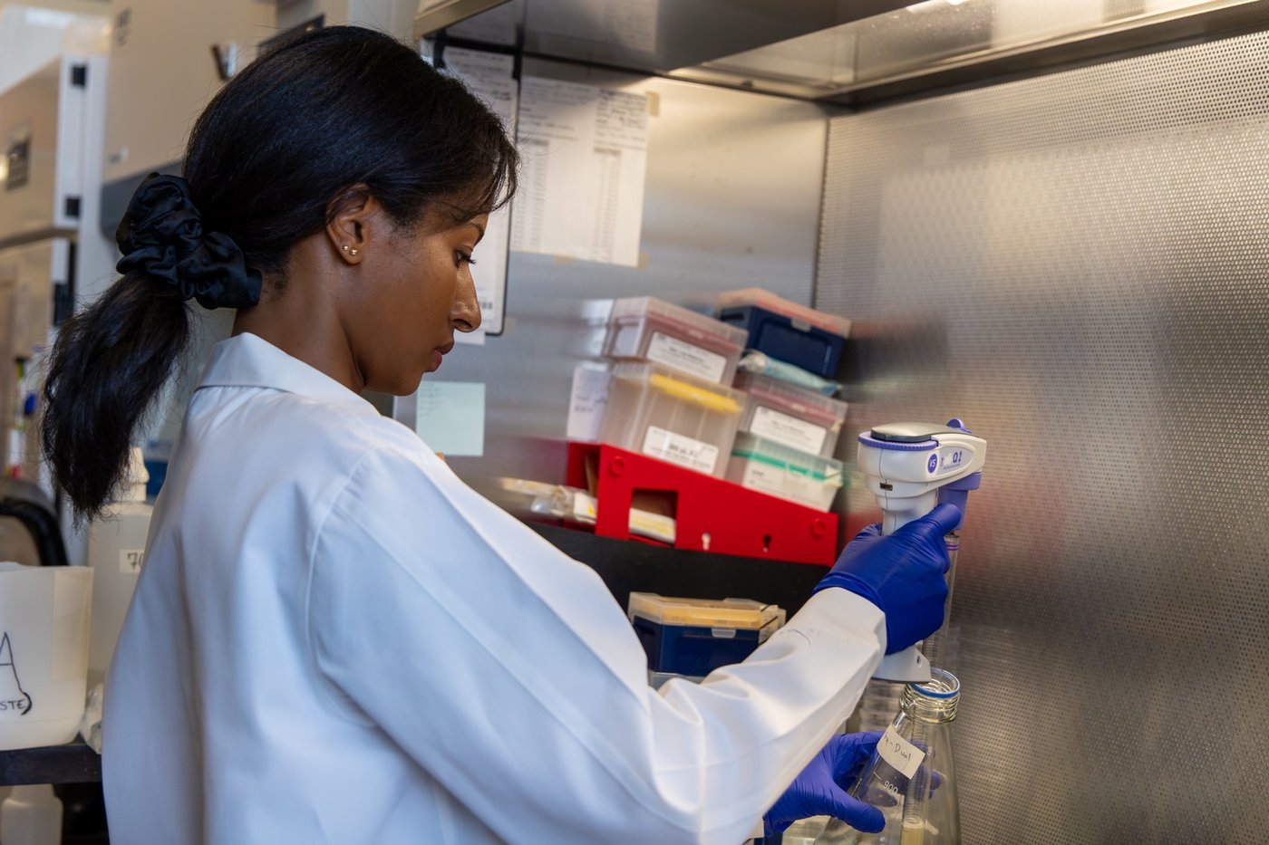 A Soilcea scientist filling a beaker in the lab.