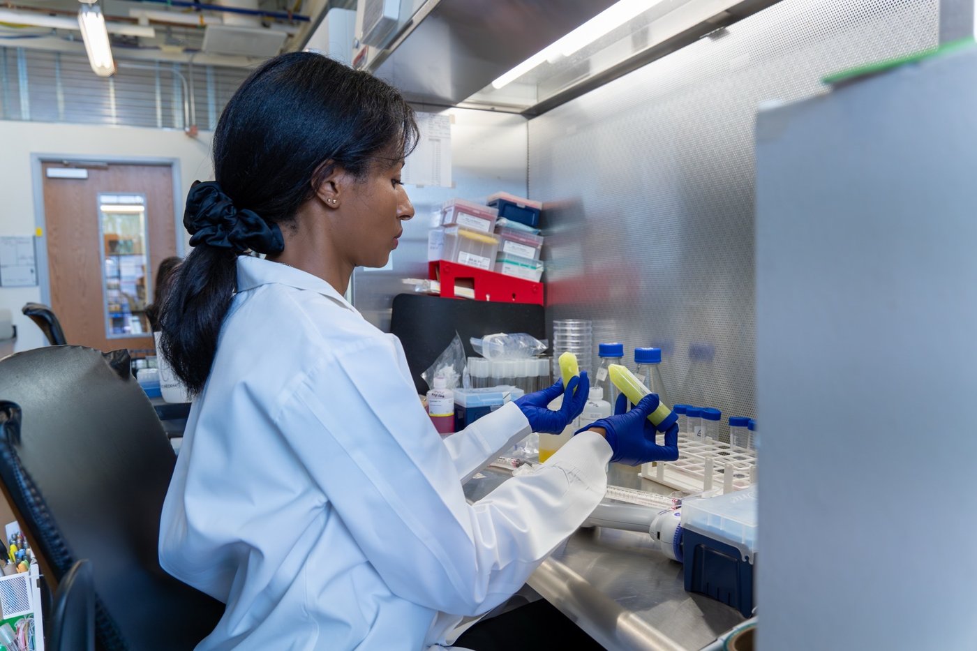 A Soilcea scientist holding sample vials.